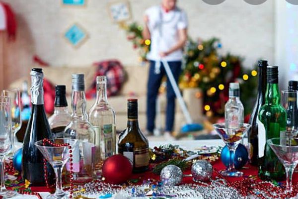 Image of a messy foreground with a cleaner vacuuming in a blurred background | Kim Kleans